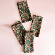 Green floral-patterned fabric on a pink background