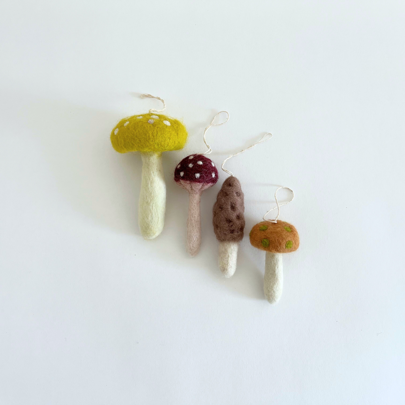 Set of five mushroom-shaped ornaments on a white background

