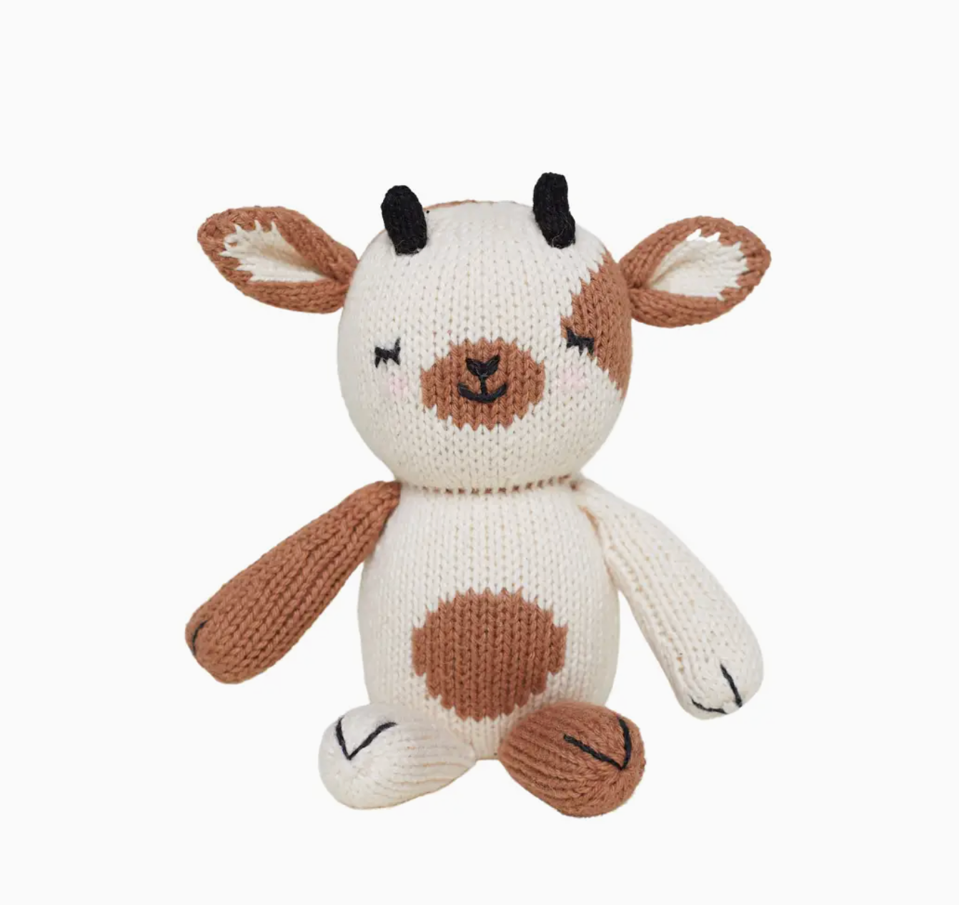 Knitted toy cow with brown spots on a white background