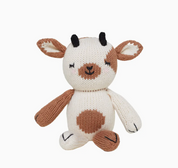 Knitted toy cow with brown spots on a white background