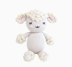 Knitted toy sheep on a white background