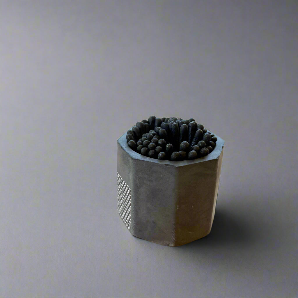 Hexagonal black container with matches 
