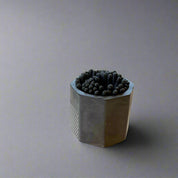Hexagonal black container with matches 