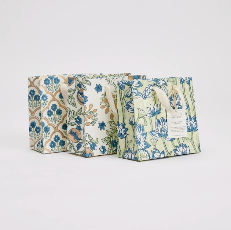 Three floral-patterned bags on a light gray background