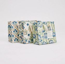 Three floral-patterned bags on a light gray background