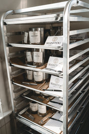 Metal shelving unit with manitou candle co. classroom trays