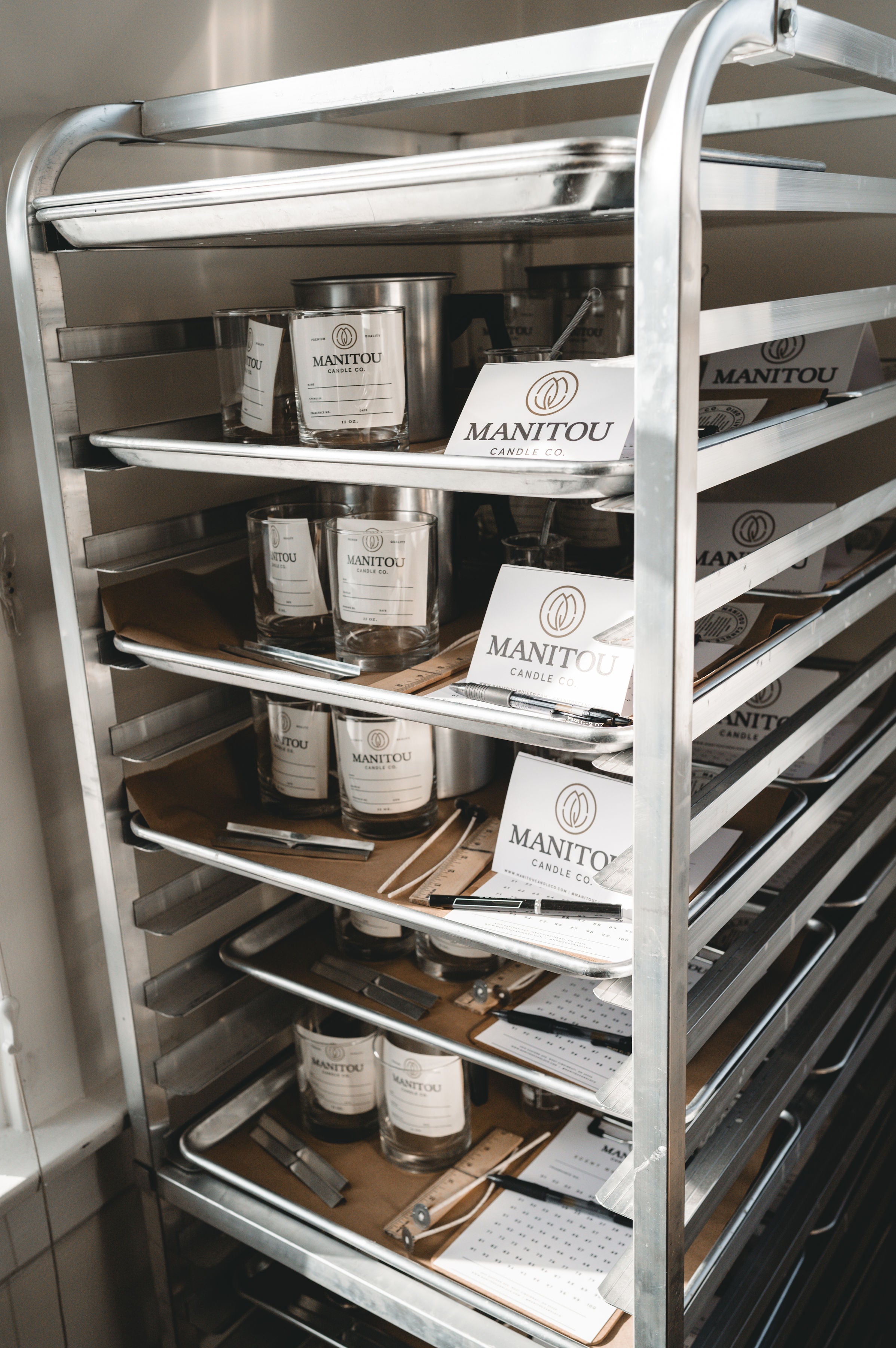 Metal shelving unit with manitou candle co. classroom trays