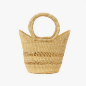 Woven straw handbag with circular handles on a white background
