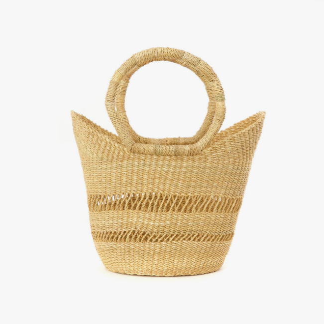 Woven straw handbag with circular handles on a white background