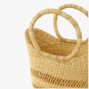 Woven handbag with circular handles on a white background