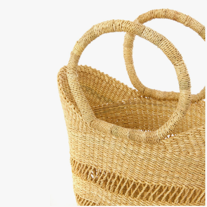 Woven handbag with circular handles on a white background