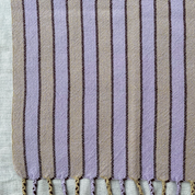 Striped towel with tassels on a light background