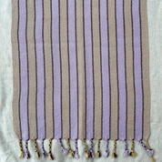 Striped fabric with tassels on a light background