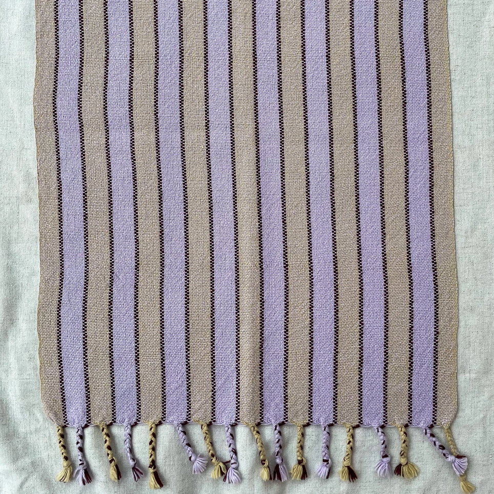 Striped fabric with tassels on a light background