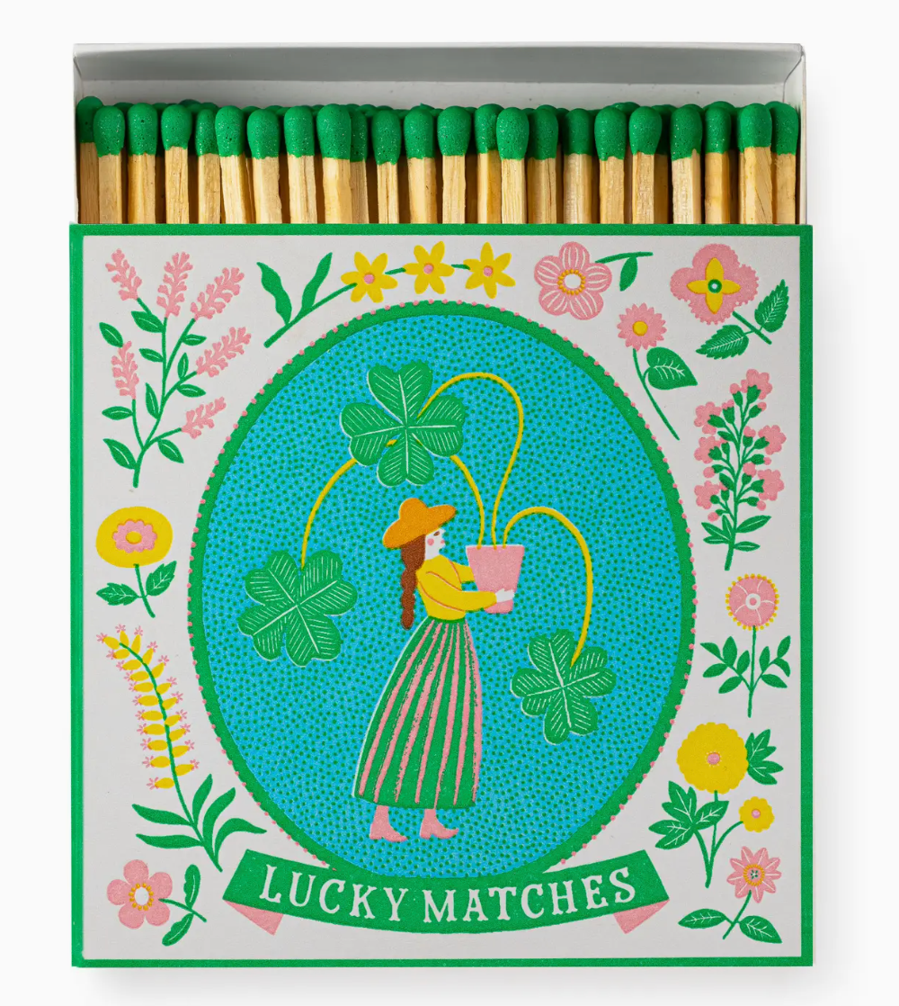 Matches with a decorative box featuring a woman and flowers, labeled &#39;Lucky Matches&#39;.