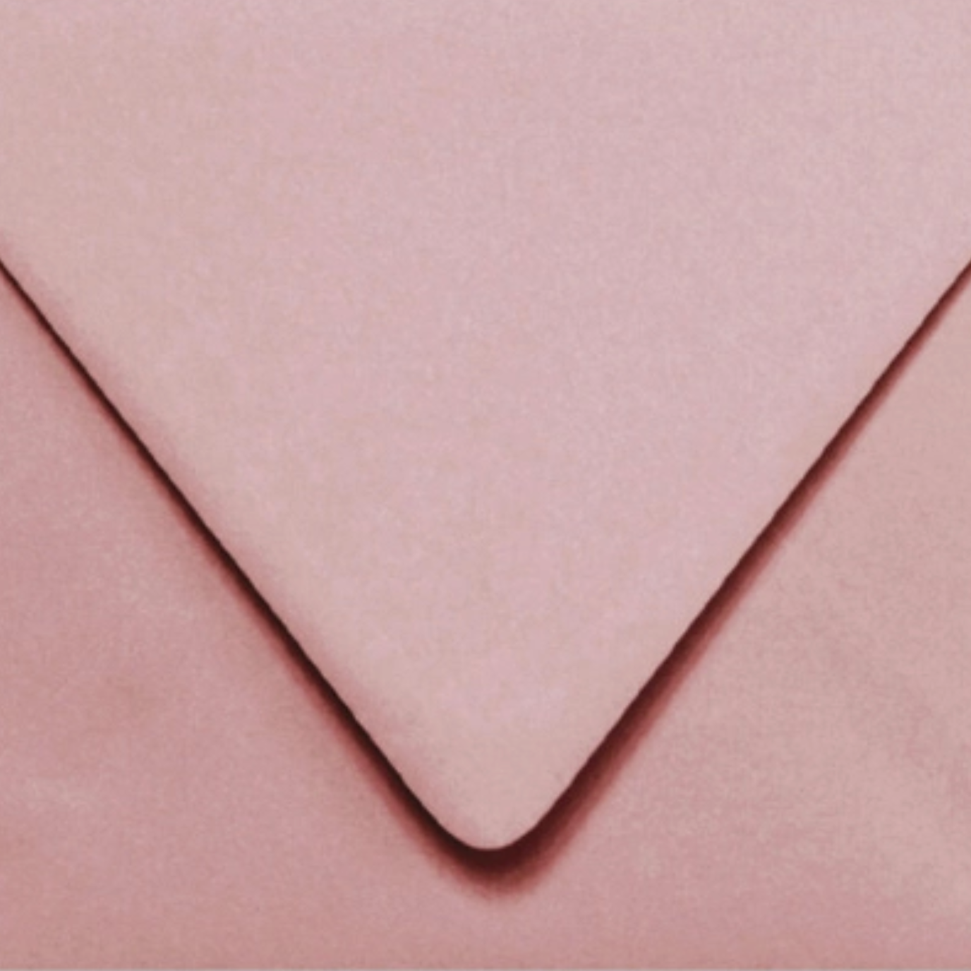 Close-up of a mauve envelope with a focus on texture and color.