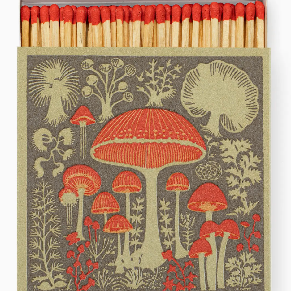 Matches with mushroom design on a gray background