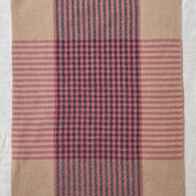 Plaid fabric with pink and black stripes on a white background