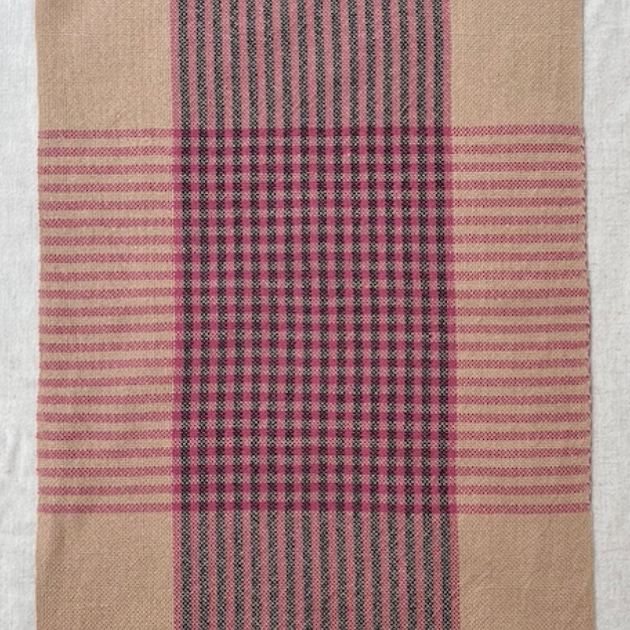 Plaid fabric with pink and black stripes on a white background