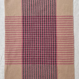 Plaid fabric with pink and black stripes on a white background