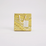 Gift bag with marbled design and handle on a white background