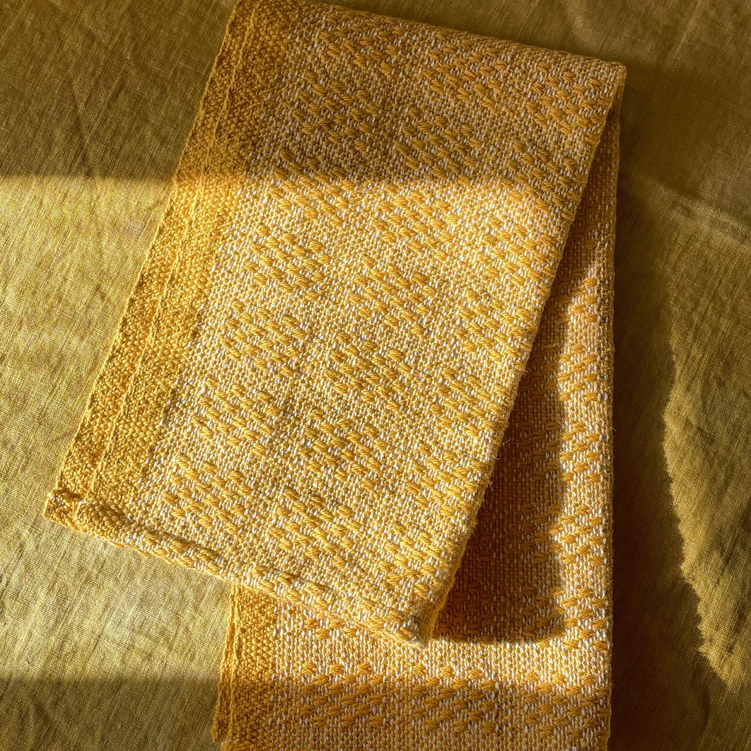 Folded gold fabric on a textured surface