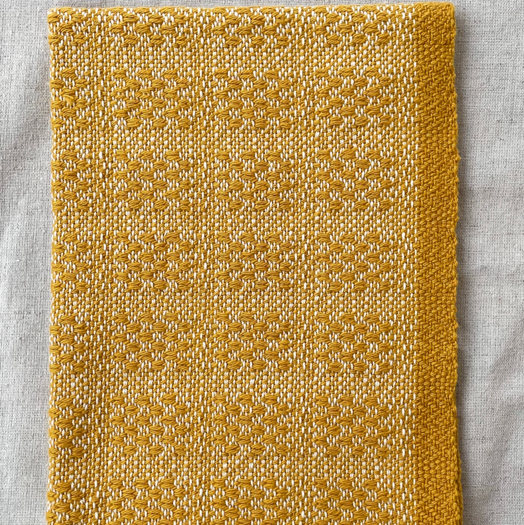 Gold textured square on a light gray background