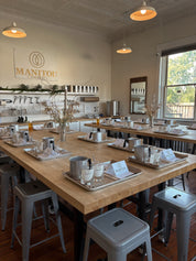 class area with wooden counter and Manitou Candle Co. logo on the wall
