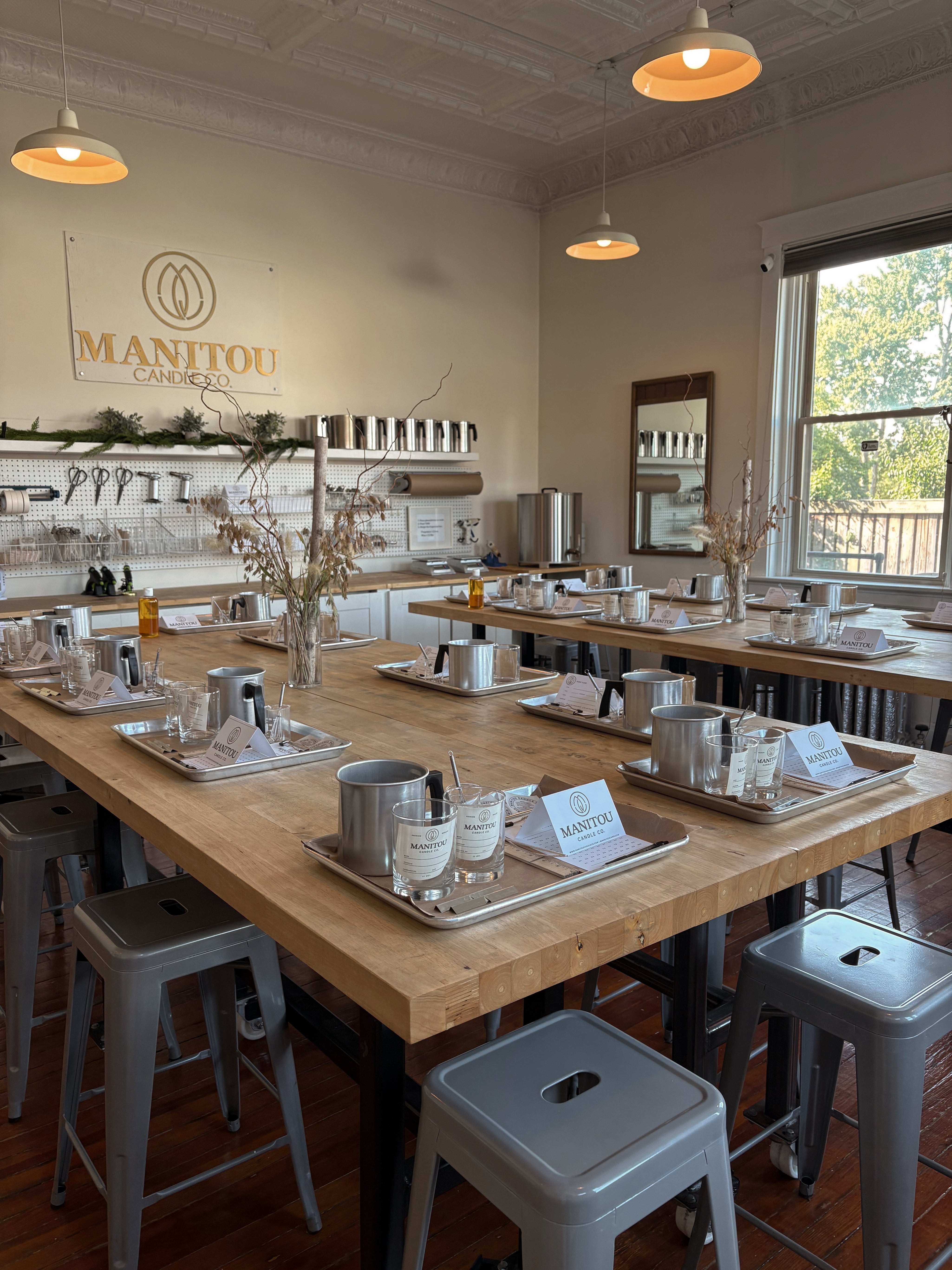 class area with wooden counter and Manitou Candle Co. logo on the wall