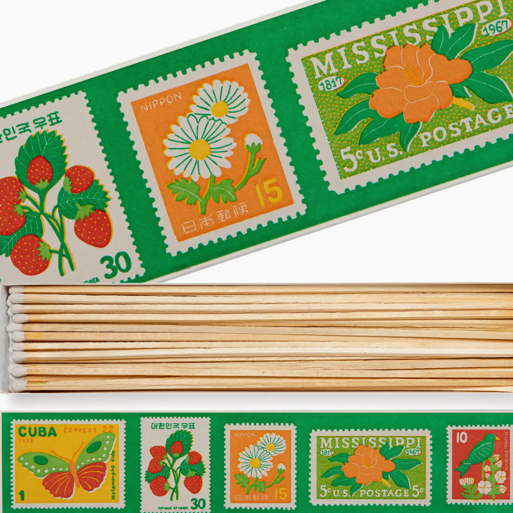 Set of wooden matchsticks with decorative stamps on a green background