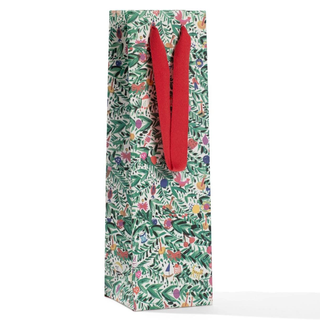 A gift bag with a Christmas-themed pattern featuring holiday tinsel and trees, and red ribbon handles.